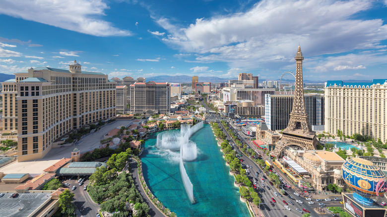 The Bellagio fountains shoot water up in the air with large casino resorts surrounding the Las Vegas Boulevard location.