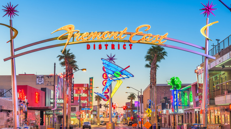 A metal arch reads Fremont East District as the clear morning sky rises above the revitalized area of downtown Las Vegas.