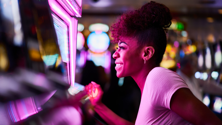 Woman playing old school slot machines at casino