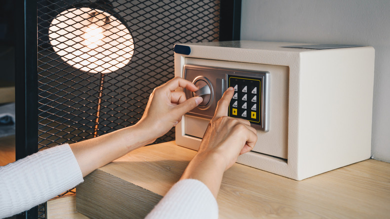 A person setting passcode on a safe