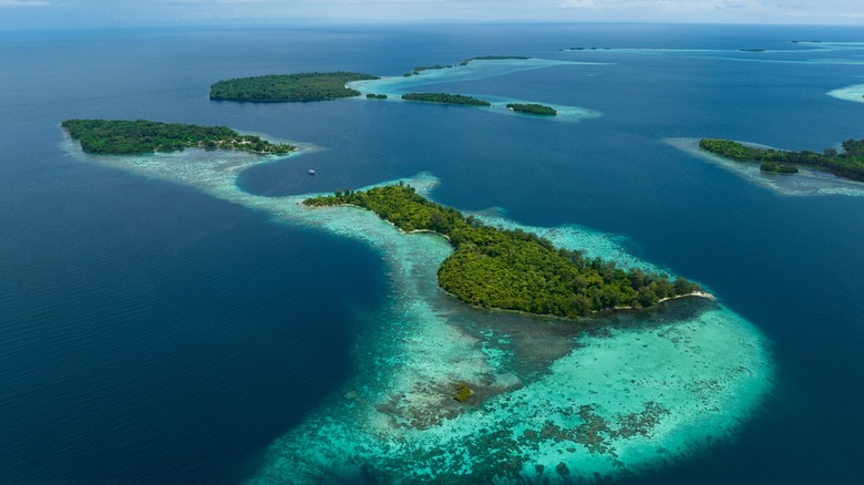 Lush, tropical islands are fringed by robust coral reefs in the Solomon Islands.