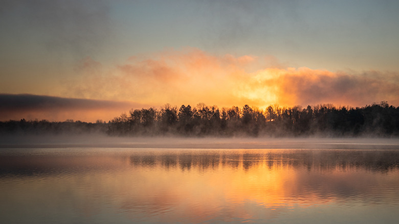 Dawn at Lake Ontelaunee with fog on the water and golden clouds in the morning sky.