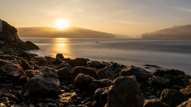 The sun sets over an ice-covered Lake Arthur in Pennsylvania