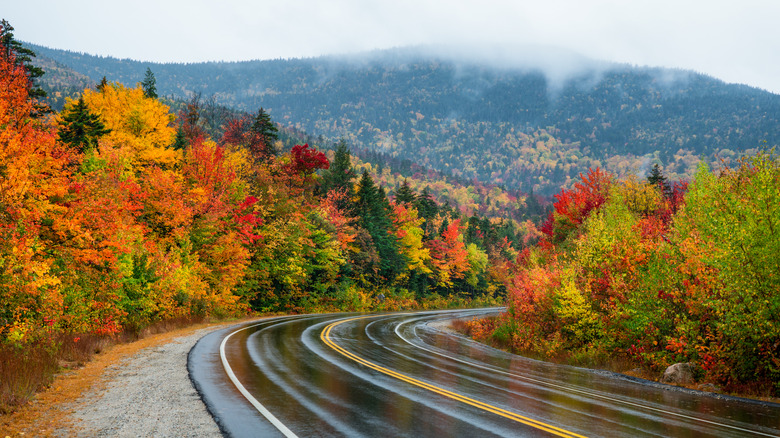 A road through New Hampshire's White Mountains lined with colorful fall foliage