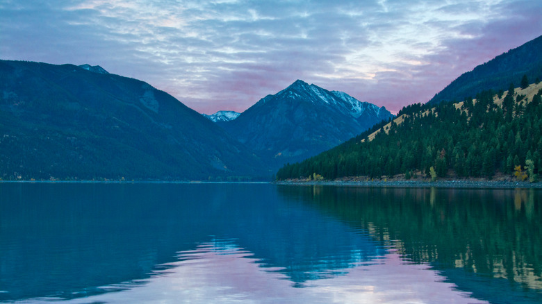 Wallowa Lake in Oregon, with purple clouds at dusk behind mountains
