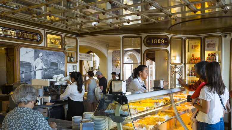 Interior of Lisbon's Confeitaria Nacional, busy with people ordering pastries