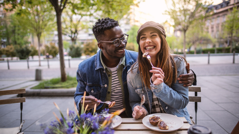 Couple eating food on patio