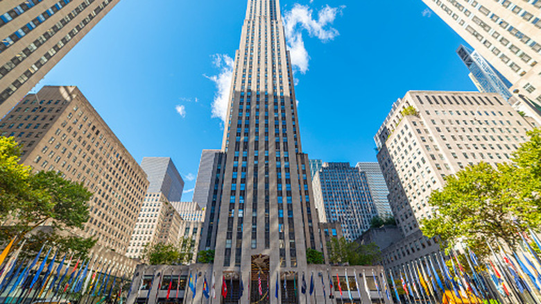 Low-angle view of the Rockefeller Center and other buildings in Rockefeller Plaza in Midtown Manhattan, New York City, pictured on a bright sunny day