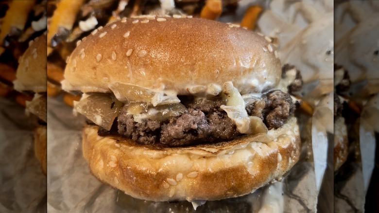 One of Farm Burger's signature burgers in a basket with fries in the background