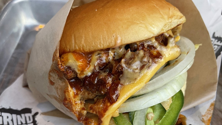 A signature burger at Grindhouse Killer Burgers in Atlanta, wrapped in the restaurant's branded paper