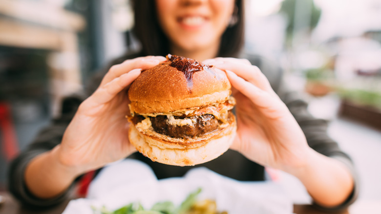 Woman holding a burger