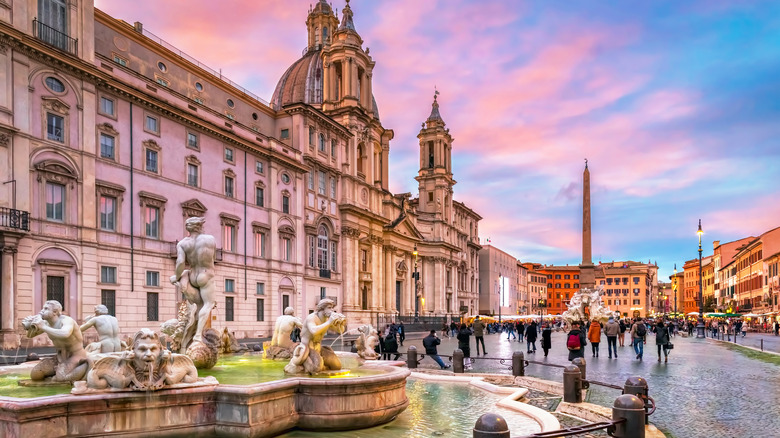 Italian square with fountain, tourists