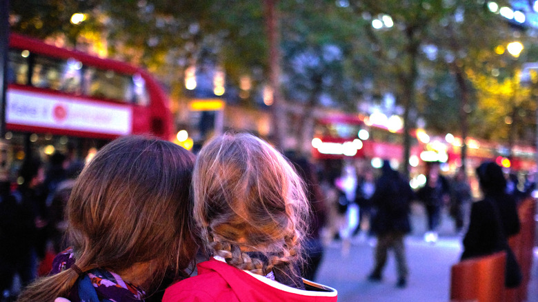 A glowing image of a woman and her daughter seen from behind as they gaze upon London's Covent Garden