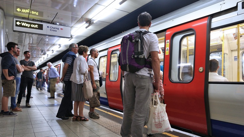 People standing on the platform of the Underground waiting to board the train carriage