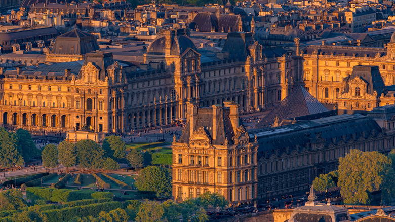 An aerial view of the Louvre museum in Paris at sunset