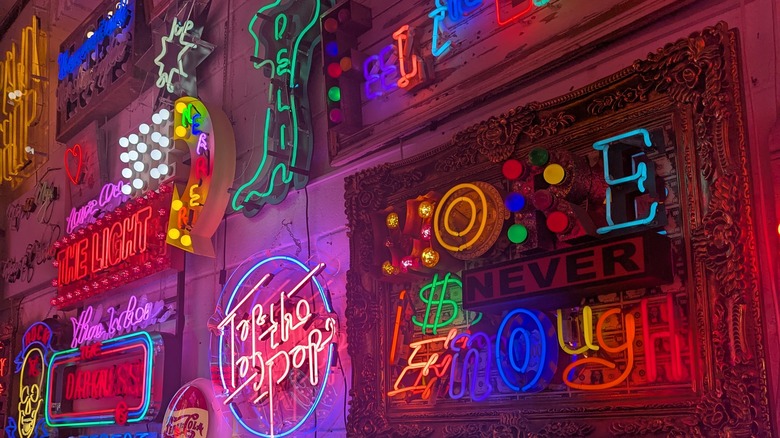 Neon signs on a wall at God's Own Junkyard
