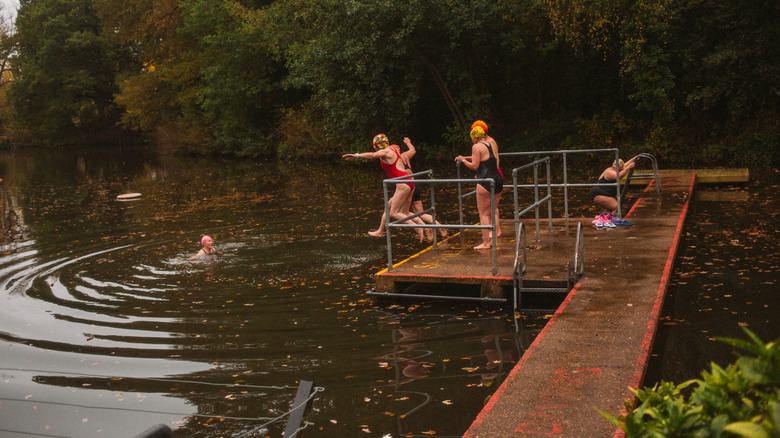 People jump off the deck into the women's pool in Hamptsead Heath