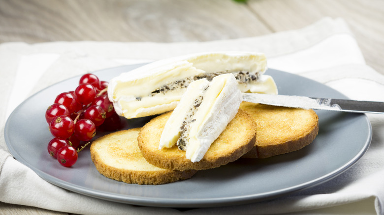 Plate of soft ripened cheese with accompaniments