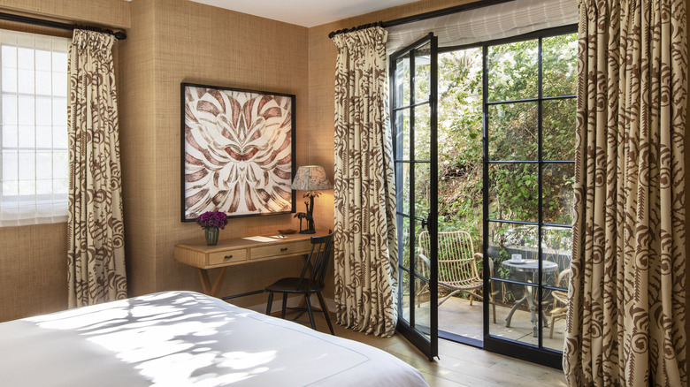 Hotel room with door open to outdoor patio.