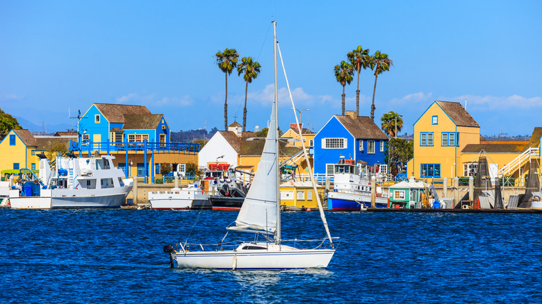 Sail boat and colorful buildings at Fisherman's Village, Marina del Rey