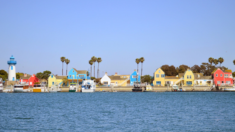 Row of colorful buildings backed by palm trees at Fisherman's Village, Marina del Rey