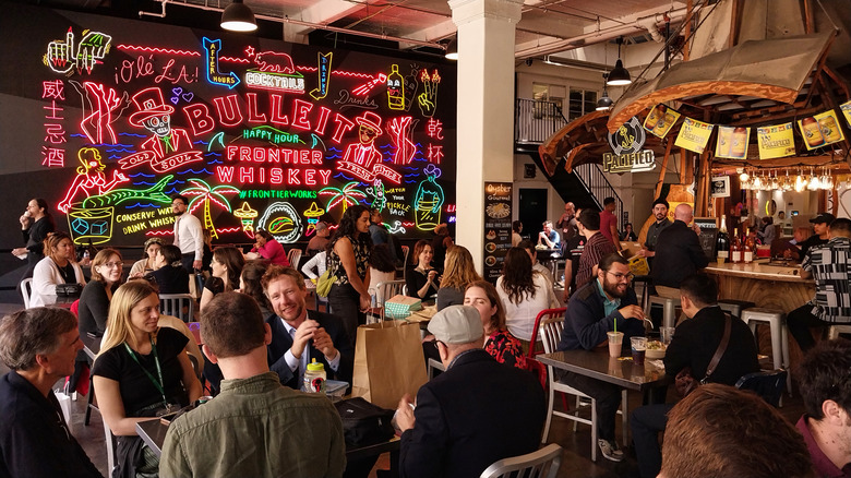 Diners in Grand Central Market eat under nostalgic neon
