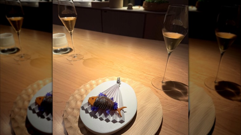 A plate and glass of wine at Somni