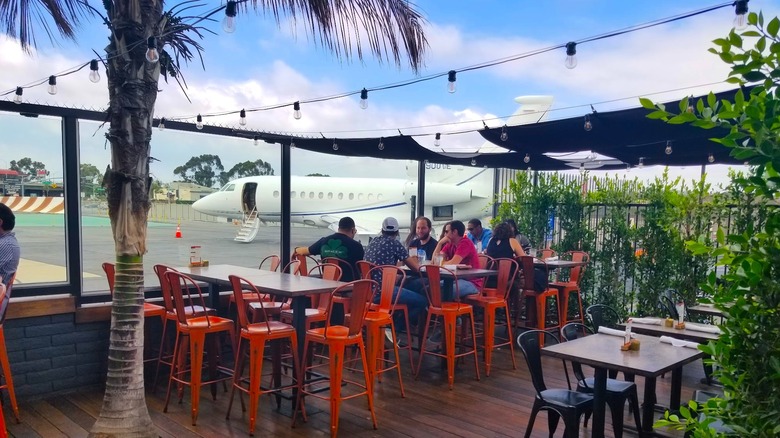 Eureka! restaurant terrace in Hawthorne, California, with a small plane in the background