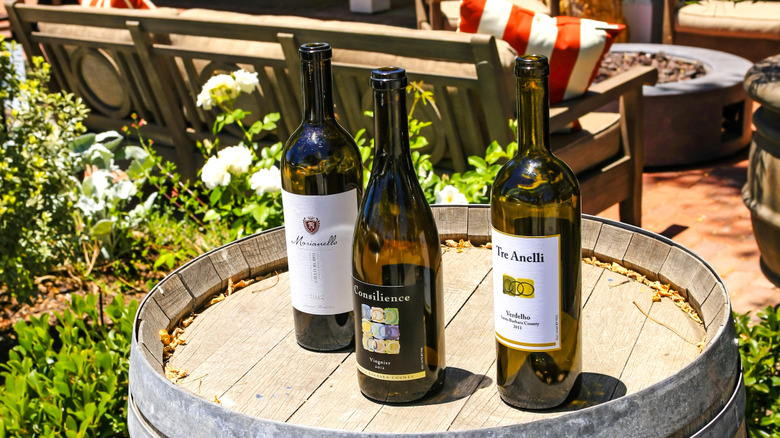 Local wine bottles on a barrel outside a restaurant in Los Olivos, California