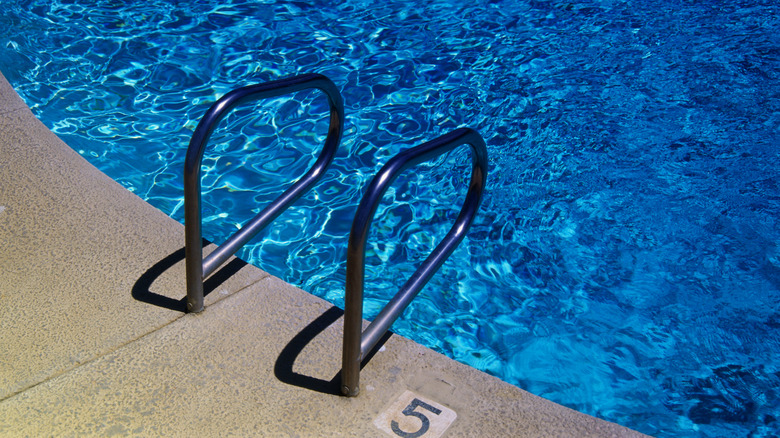 Clear blue pool with a ladder
