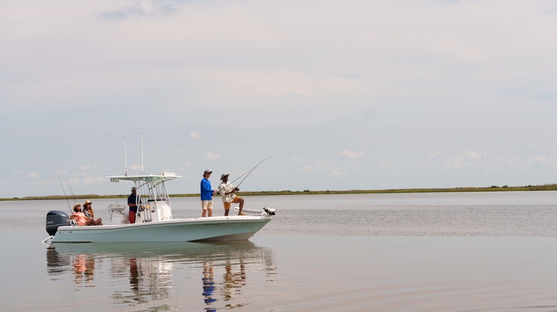 A group of people fishing off a boat