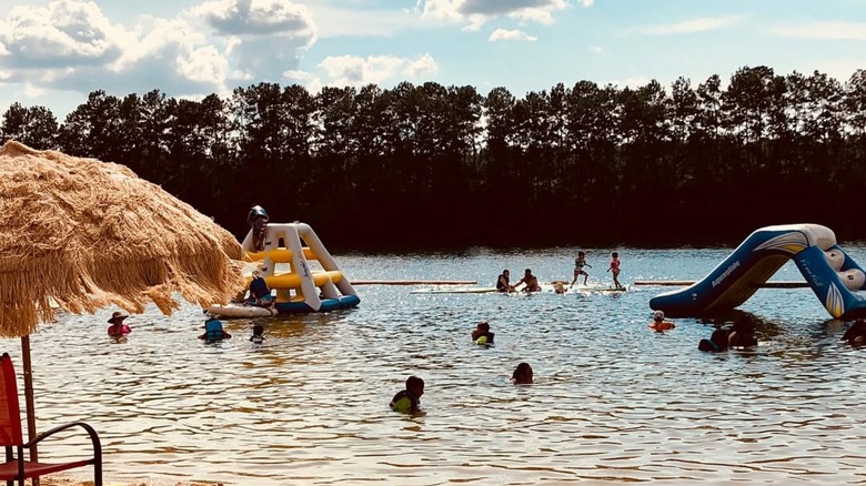 Beachgoers enjoy the lake toys at White Sands Lake Day Beach
