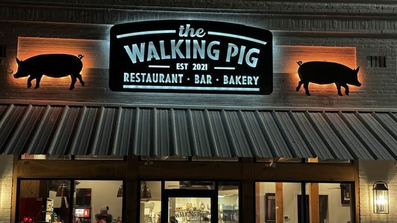 A neon sign for The Walking Pig restaurant, bar and bakery