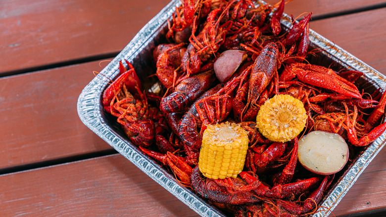 Metal dish with crawfish, corn, and potatoes