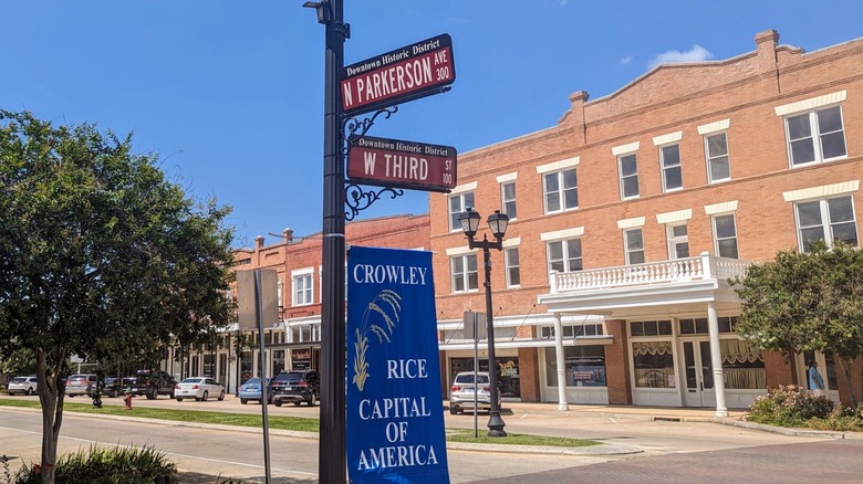 Parkerson Ave sign and W Third Sign with Rice Capital of America sign in front of red brick building