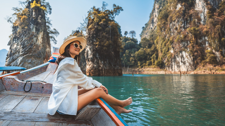 Female solo traveler sitting on a boat