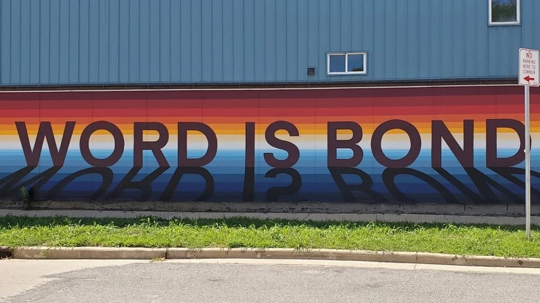 Rainbow colored mural with the words "Word is Bond"