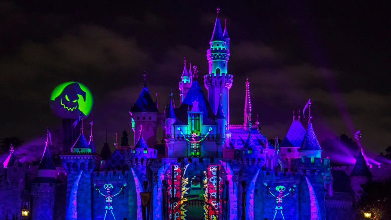 Disney Castle with Halloween-themed projections at night