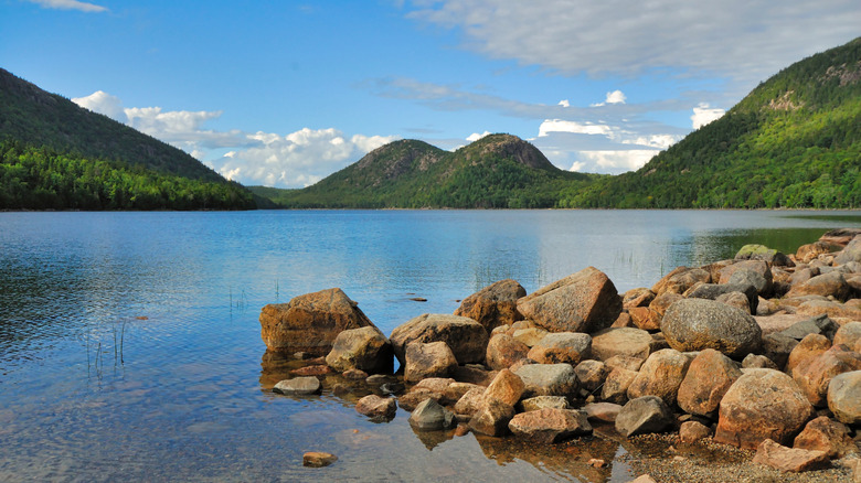 A rocky outcropping in Echo Lake with green mountains in the background