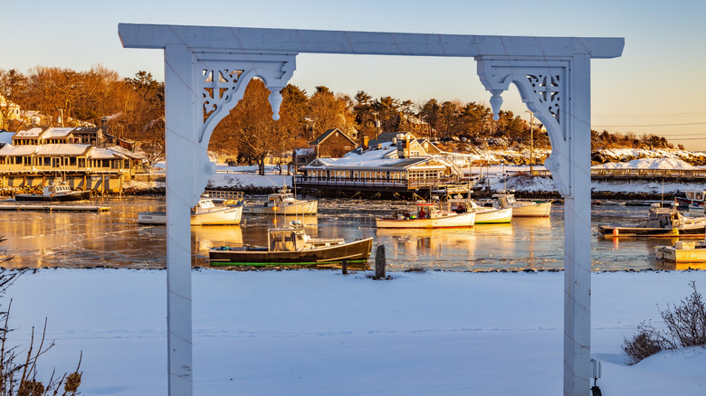 A snowy scene in Ogunquit, Maine's harbor with lobster boats