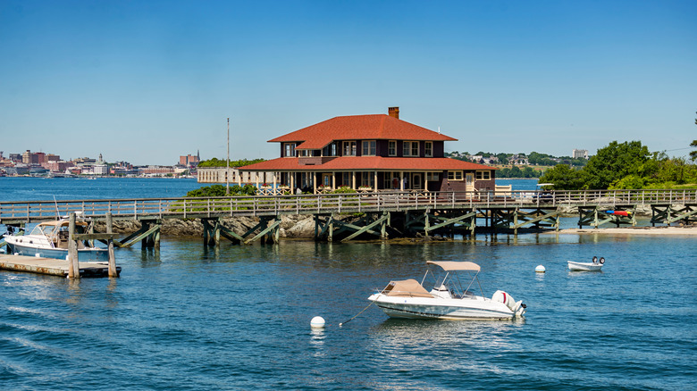 A water taxi floats next to the dock house on Great Diamond Island, Maine.