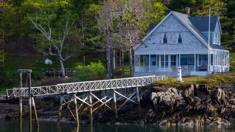 A seaside cottage with a wooden pier on Great Diamond Island, Maine.