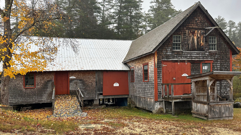 Exterior of Scribner's Mill during the day in the fall in Harrison, Maine.
