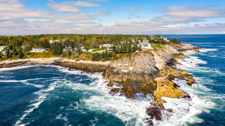 Aerial view of Bristol, Maine's lighthouse, cliffs, and coastal water