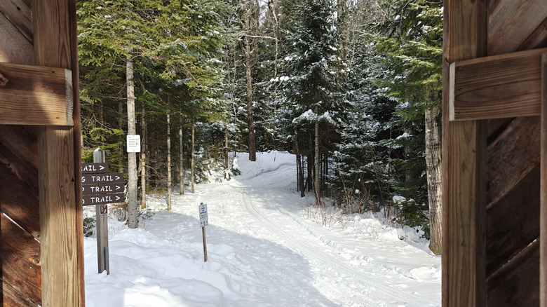 A snowy trail and trail signs at Aroostook National Wildlife Refuge in Maine