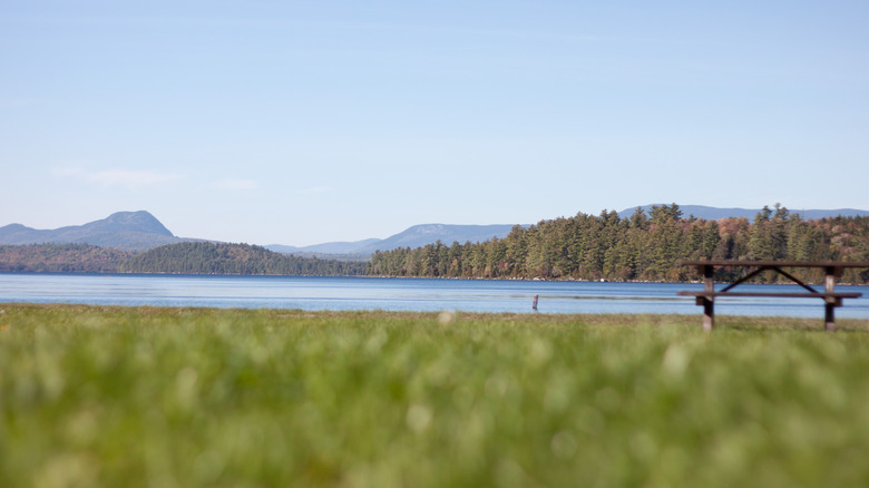 Grassy field before Sebec lake at Maine's Peaks-Kenny State Park, with Borestone Mountain in the background