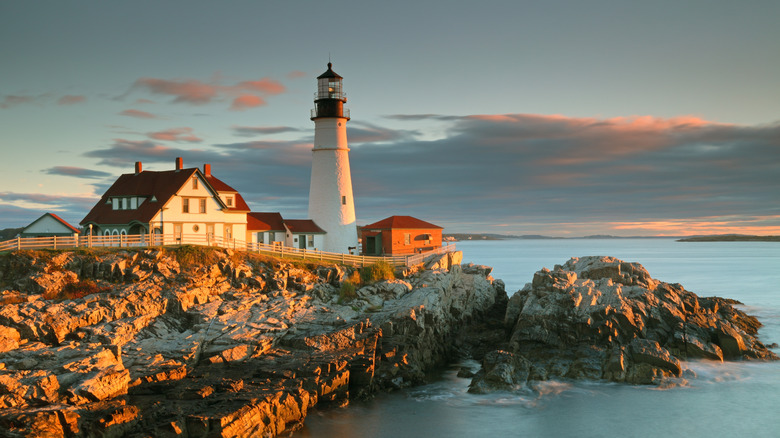 Portland Head Light on rocky coast at sunrise
