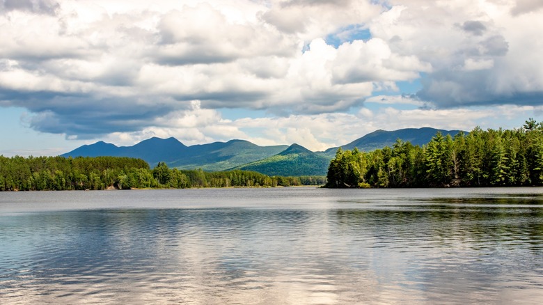 Forest mountains and a cloudy sky surrounding Flagstaff Lake in Maine