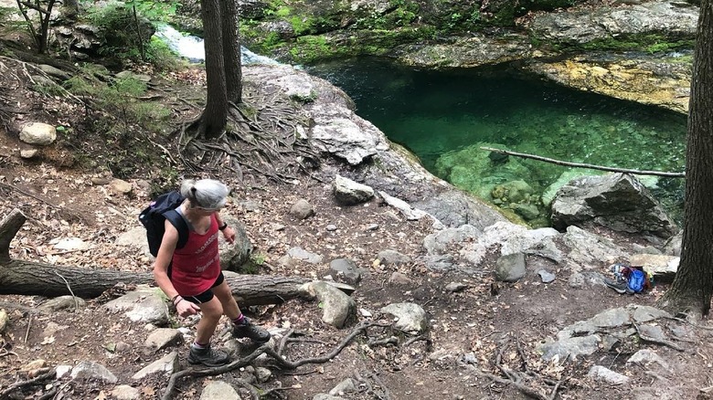 Hiker passes Rattlesnake Flume on the way to the pool
