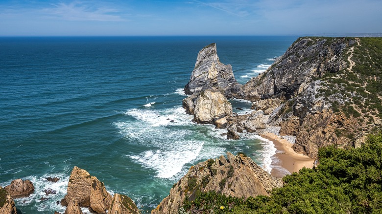 Rocky cliffs and sandy beach on coast